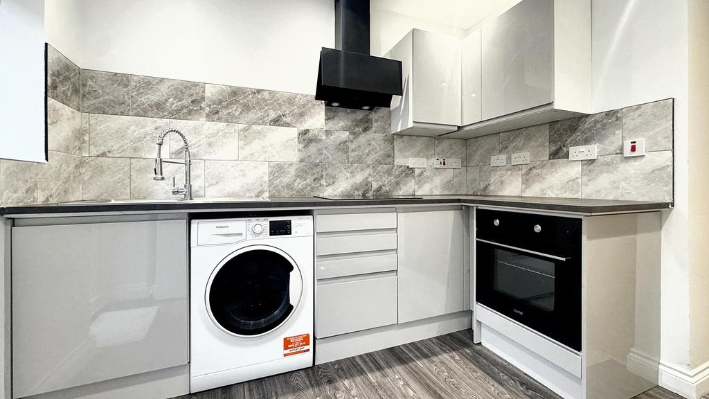 Bright modern kitchen with integrated appliance...