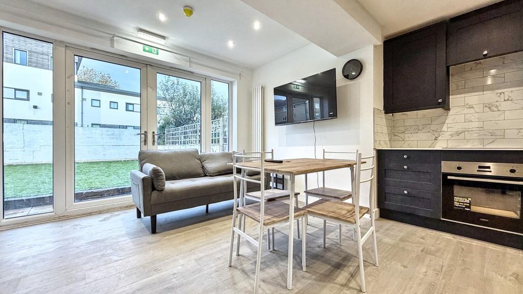 Bright open-plan living area with full-height g...