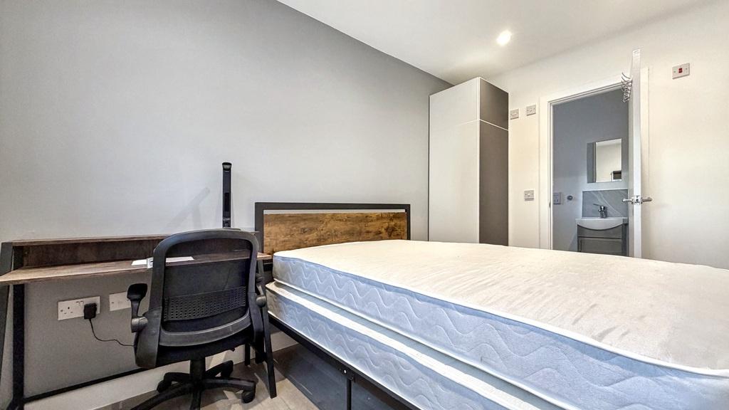 Bright, neatly presented bedroom with a comfort...