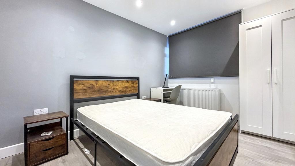 Bright, modern double bedroom with a double bed...