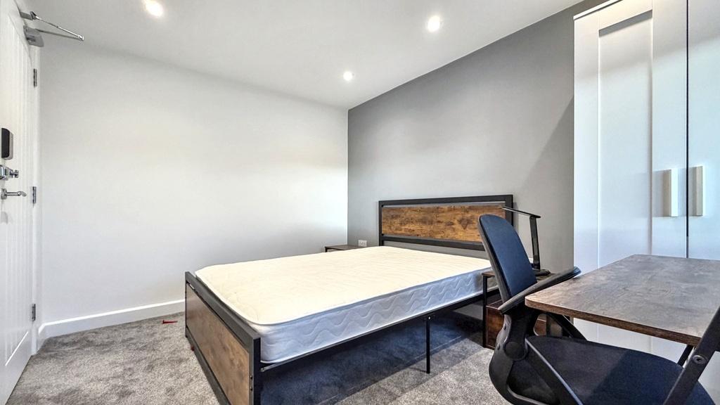 Bright, modern double bedroom with a sturdy woo...
