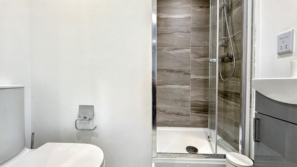 Bright, modern bathroom with a walk-in shower, ...