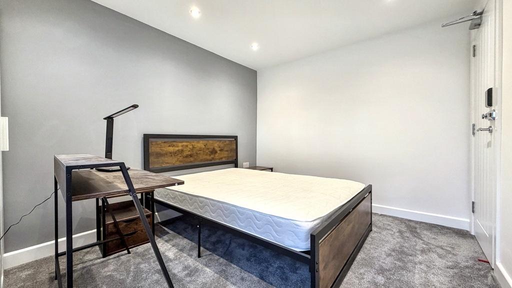 Bright, modern double bedroom with a comfortabl...