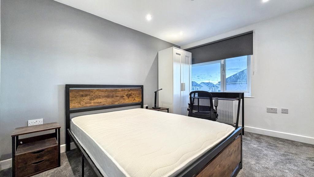 Bright, modern double bedroom with a contempora...