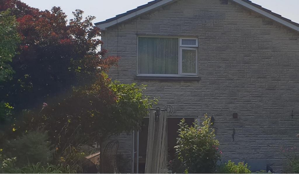 A charming exterior view of the property with w...