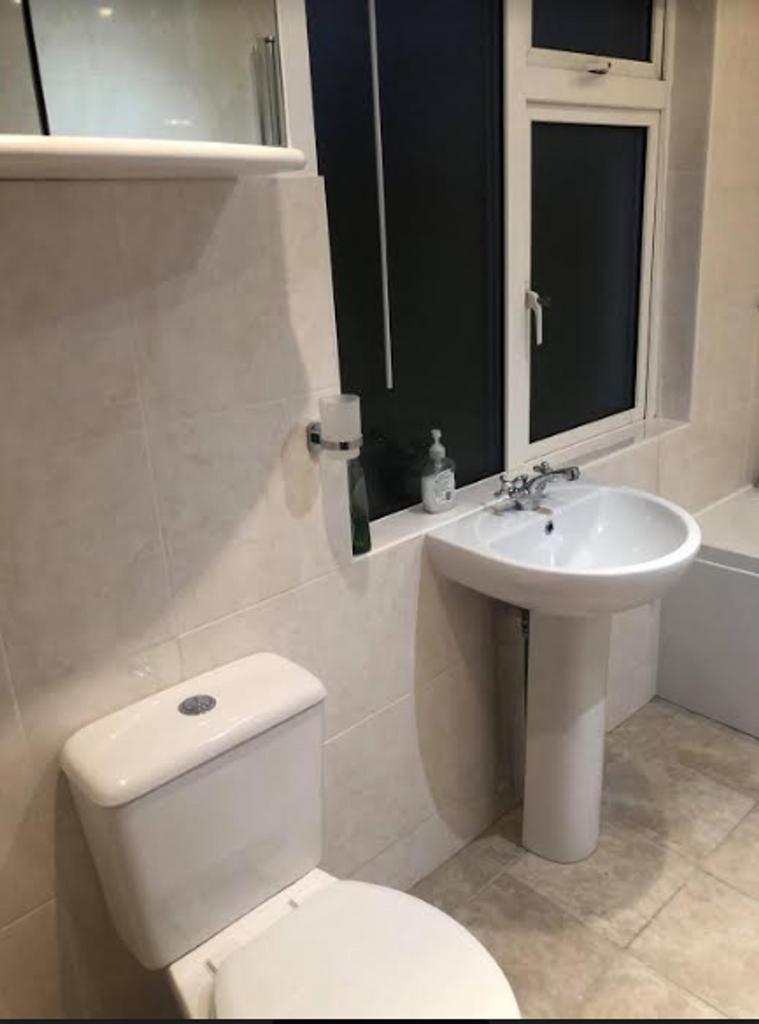 A modern and clean bathroom featuring a bath, p...