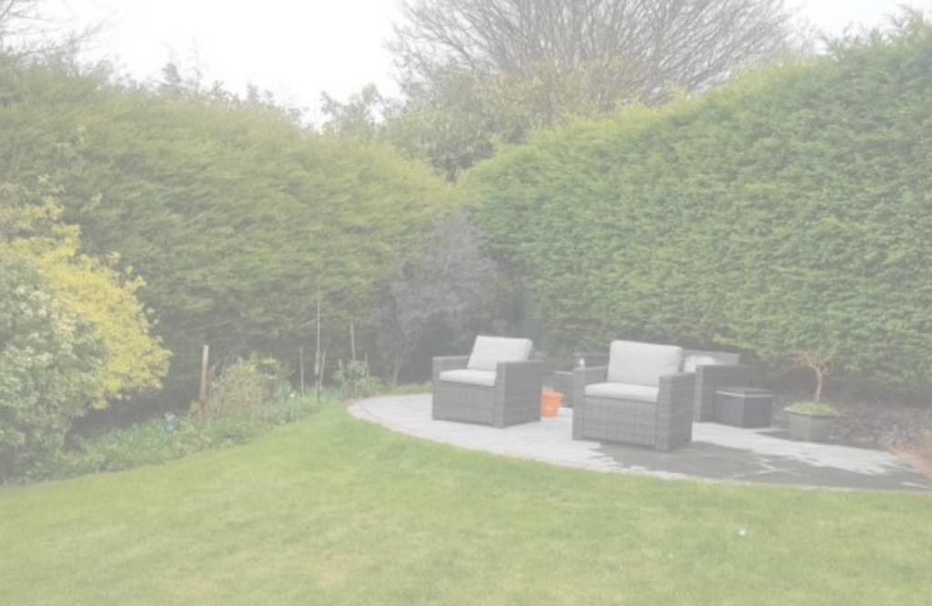 A beautifully manicured garden with comfortable...