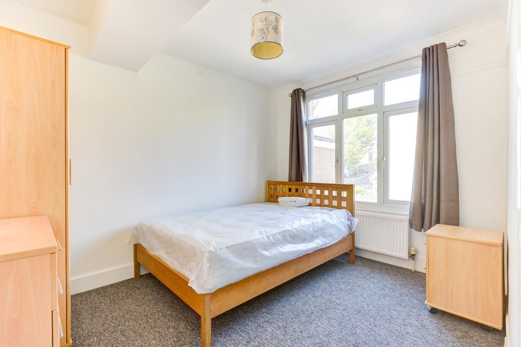 Bright and welcoming master bedroom featuring a...
