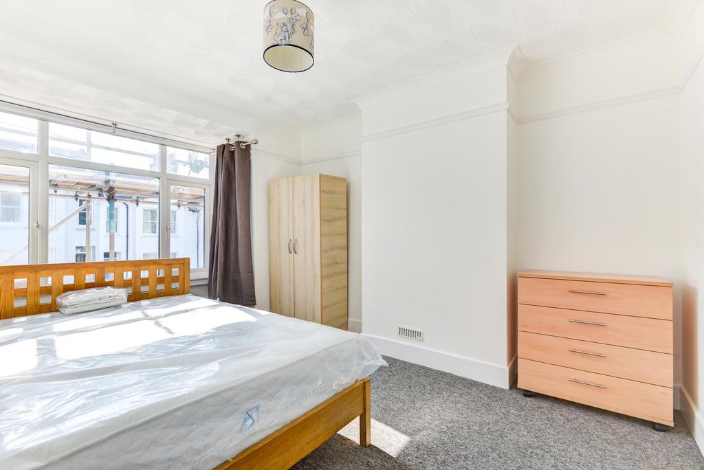 A bright and tidy bedroom featuring a double be...
