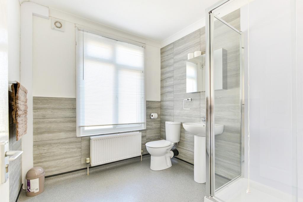 A bright and modern bathroom featuring a large ...