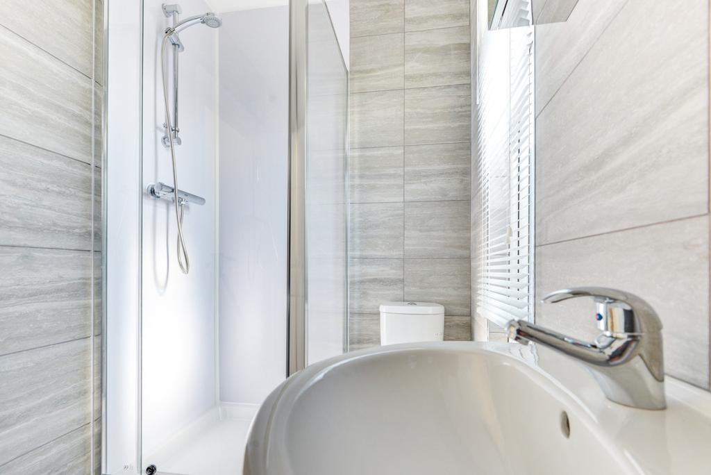 A clean and modern bathroom featuring a large s...