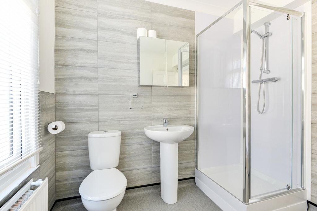 A clean, well-maintained bathroom featuring a t...