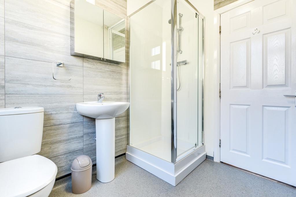 A clean and modern bathroom with a shower enclo...
