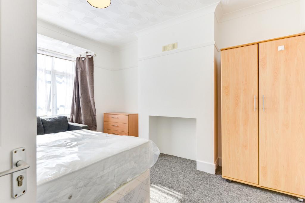 A tidy, well-lit bedroom featuring a double bed...