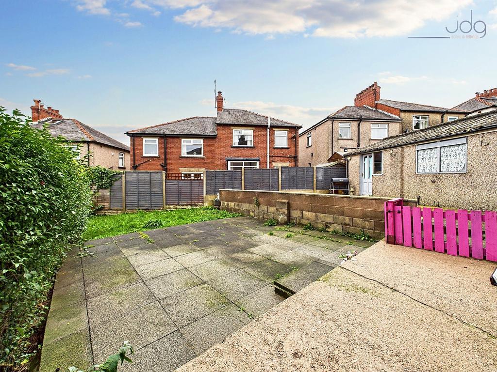 Spacious Garden with a mixture of flags and...