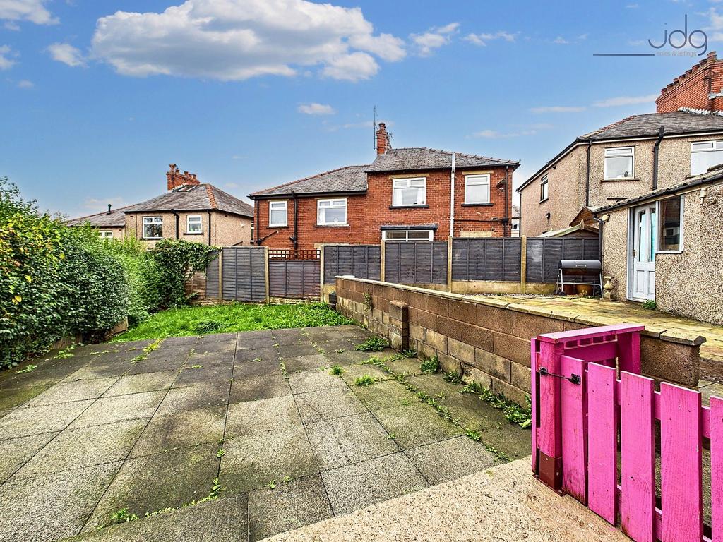 Spacious Garden with a mixture of flags and...