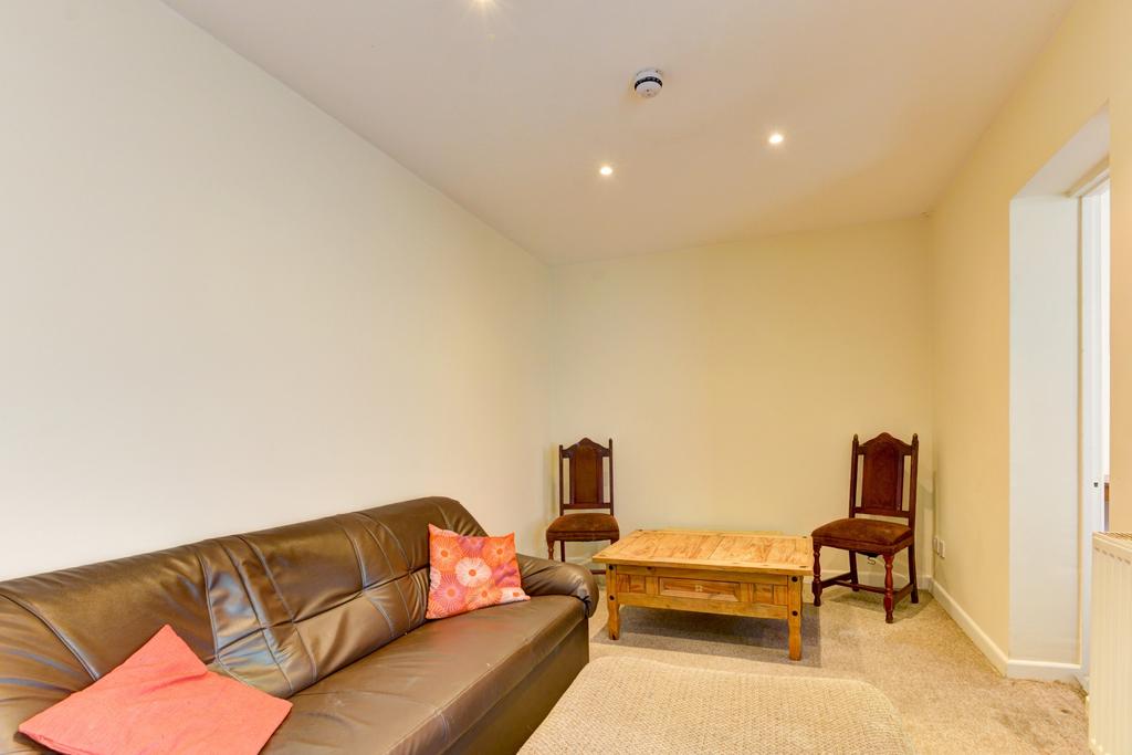 Bright and welcoming living room featuring a co...
