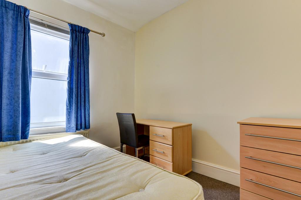 A bright, well-maintained bedroom featuring a c...