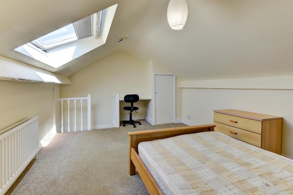 A bright and airy bedroom with a large window a...
