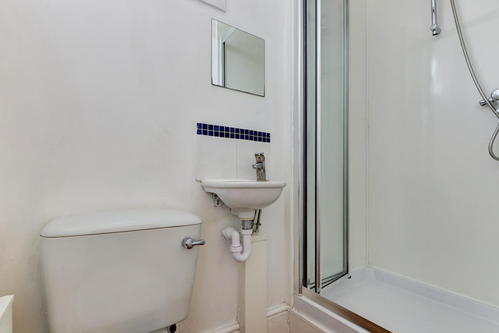 A modern bathroom featuring a toilet, small sin...