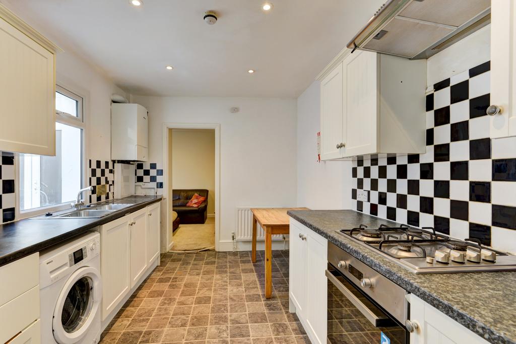 A well-maintained kitchen featuring modern whit...