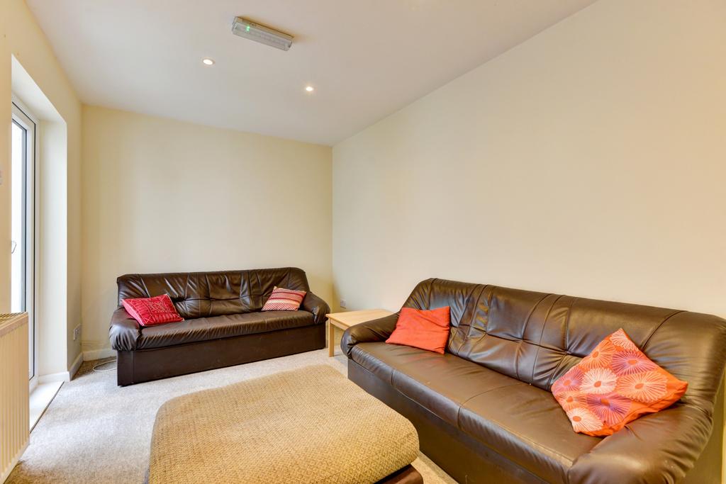 A modern and spacious living room featuring com...