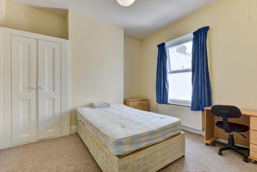 A spacious and well-lit double bedroom featurin...