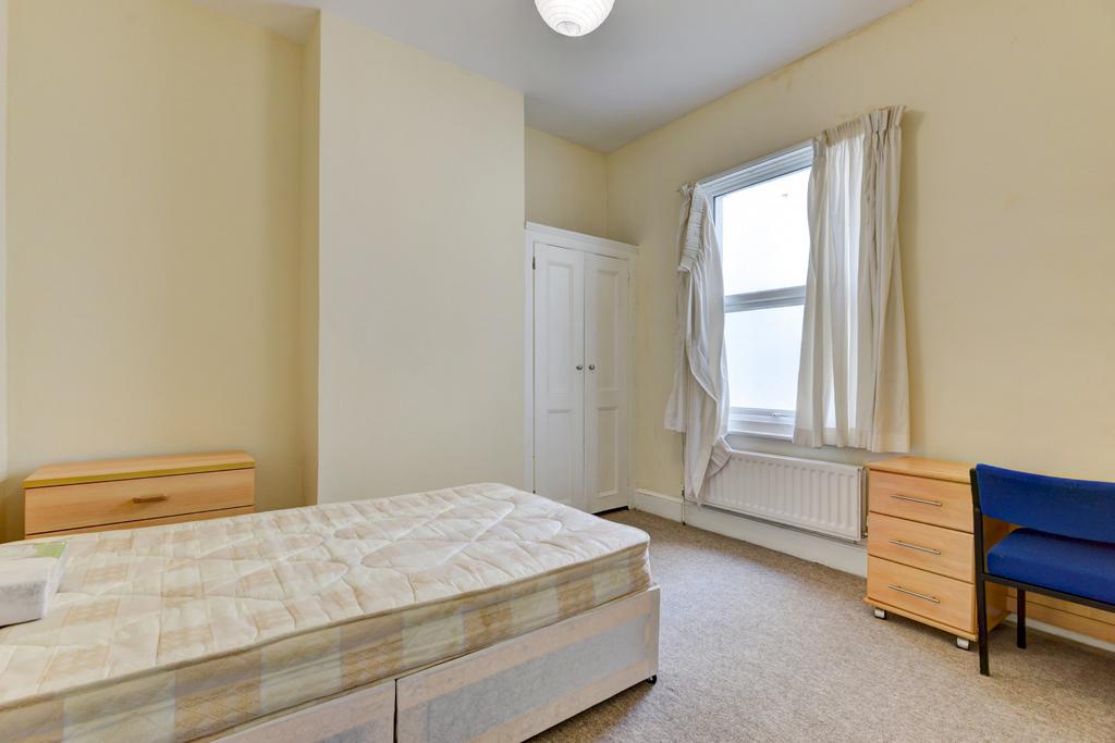 Bright and welcoming double bedroom featuring a...