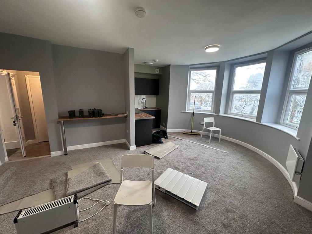 Spacious, bright living area with large bay win...