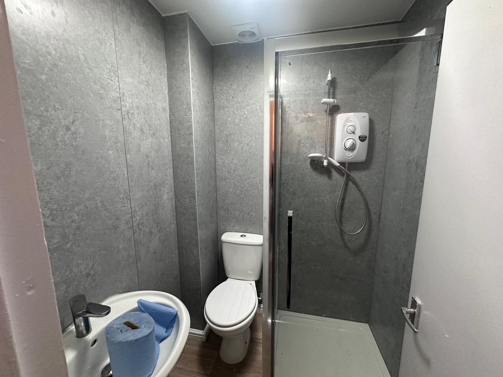 Modern compact bathroom with a walk-in shower, ...