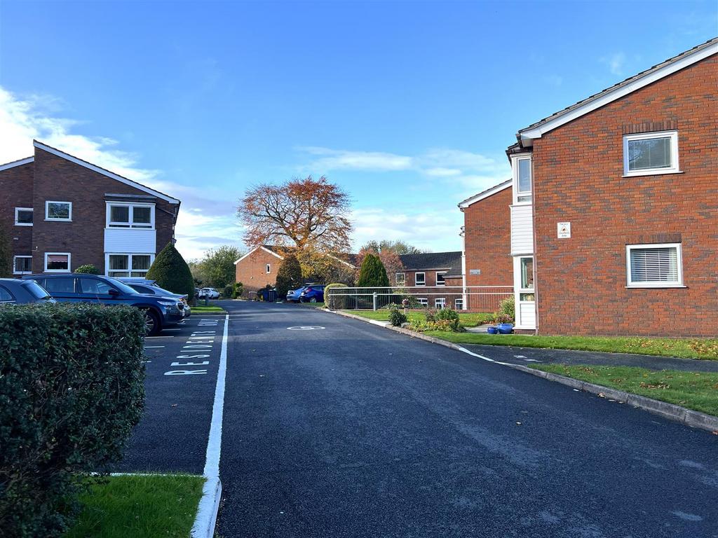 Street scene with property, parking
