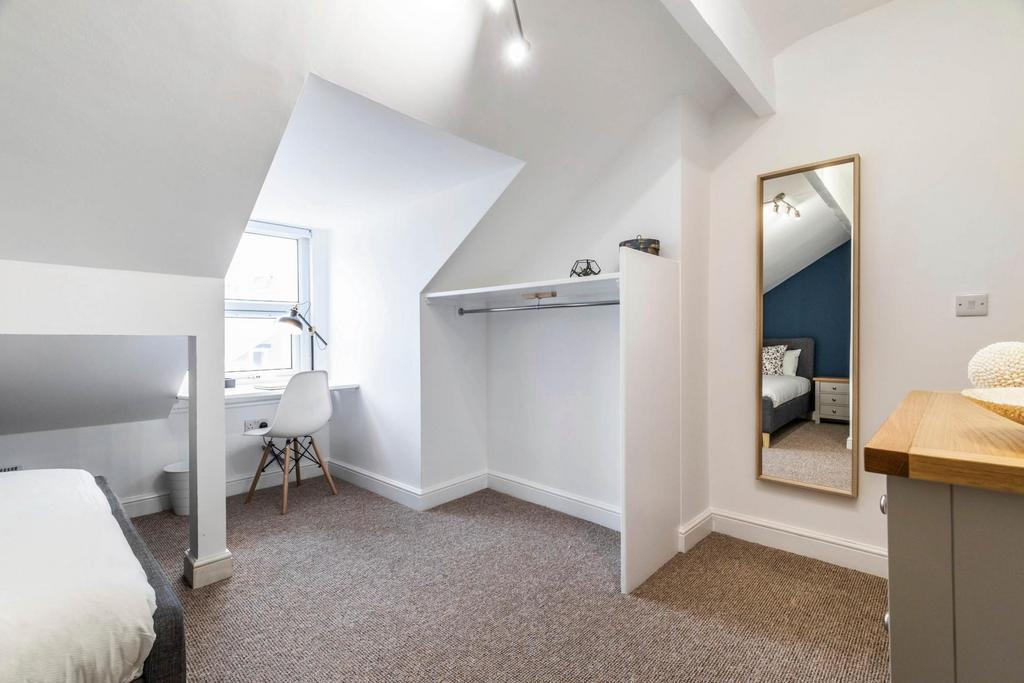 Bright, recently refreshed bedroom with a pitch...