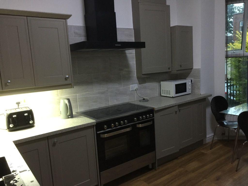Modern fitted kitchen with shaker-style cabinet...