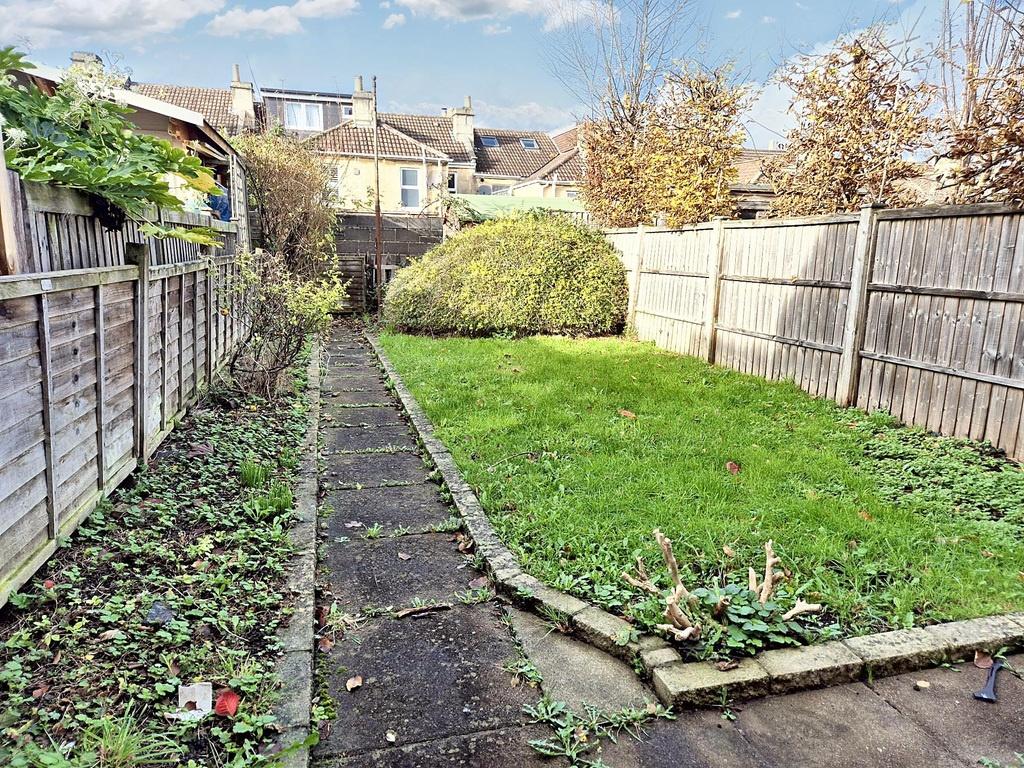 Private rear garden with a paved path leading t...