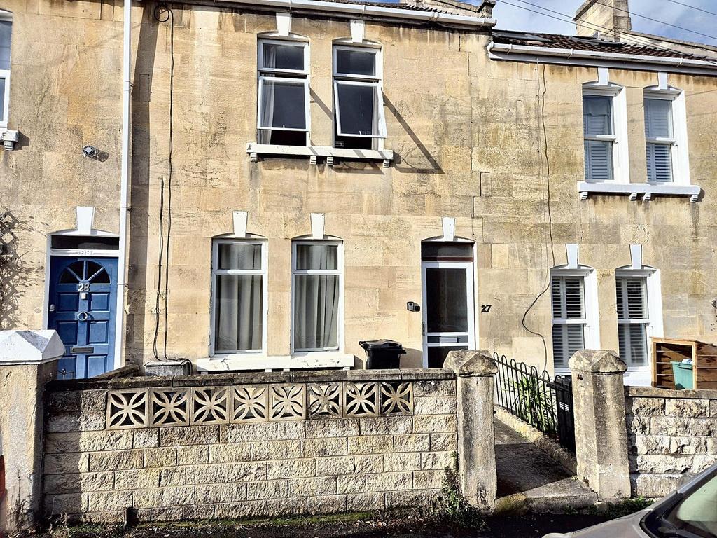 Traditional stone-front terraced house with tal...