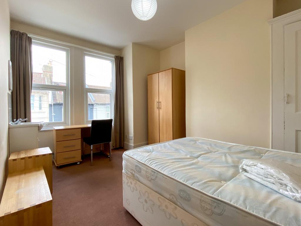 A bright and spacious master bedroom with large...