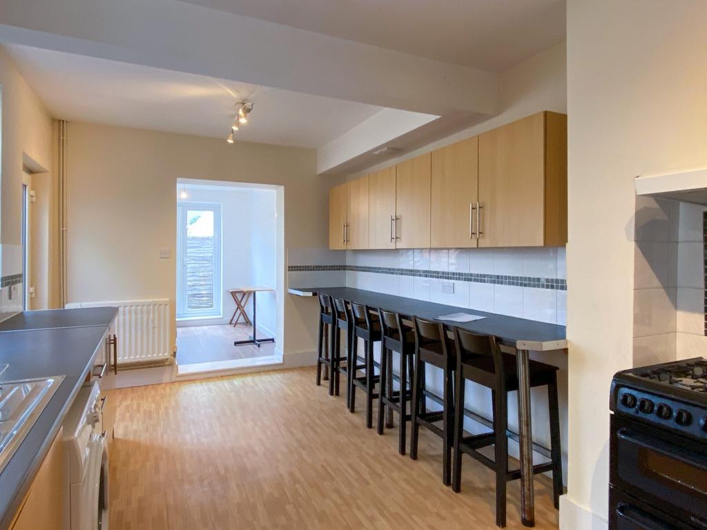 A bright and modern kitchen featuring ample cou...