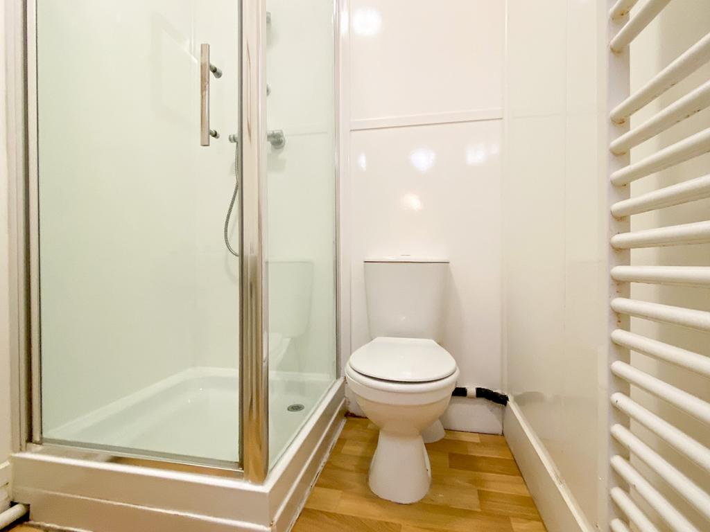 A bright and clean bathroom with a spacious sho...