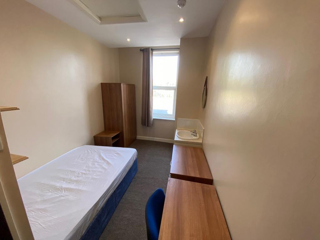 A bright and tidy double bedroom featuring ampl...