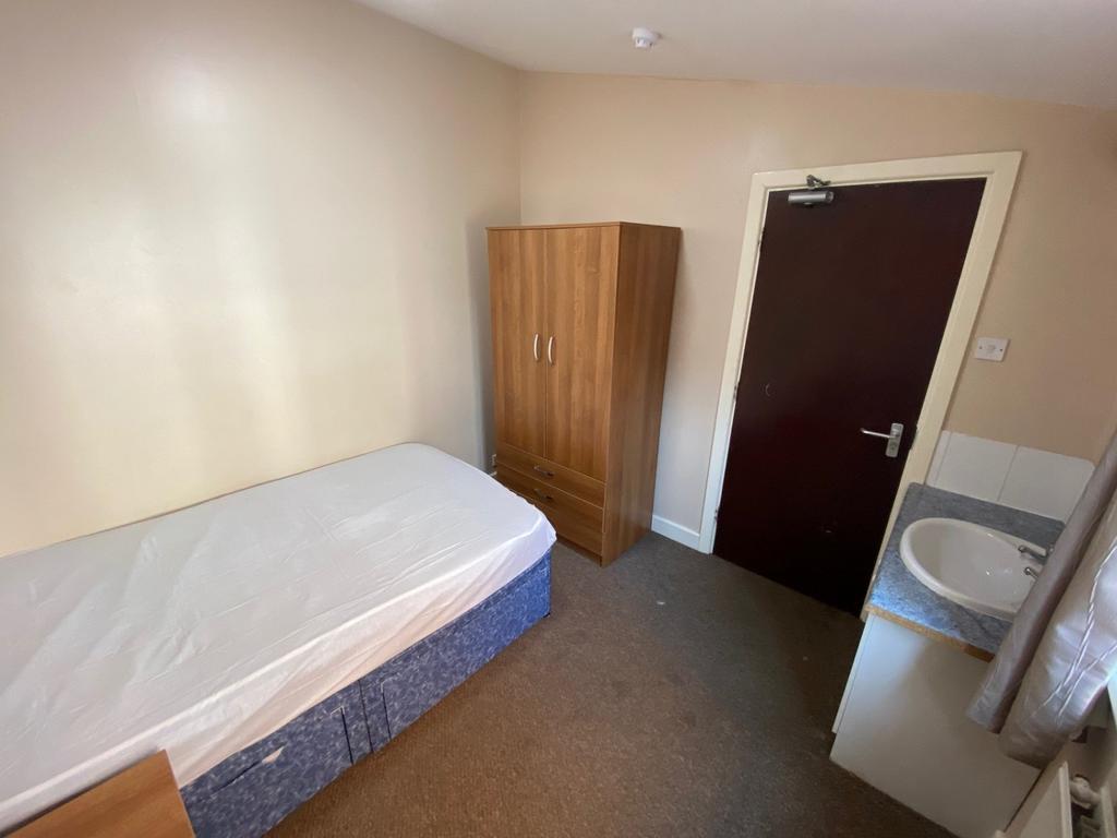 A cozy and well-lit single bedroom, perfect for...