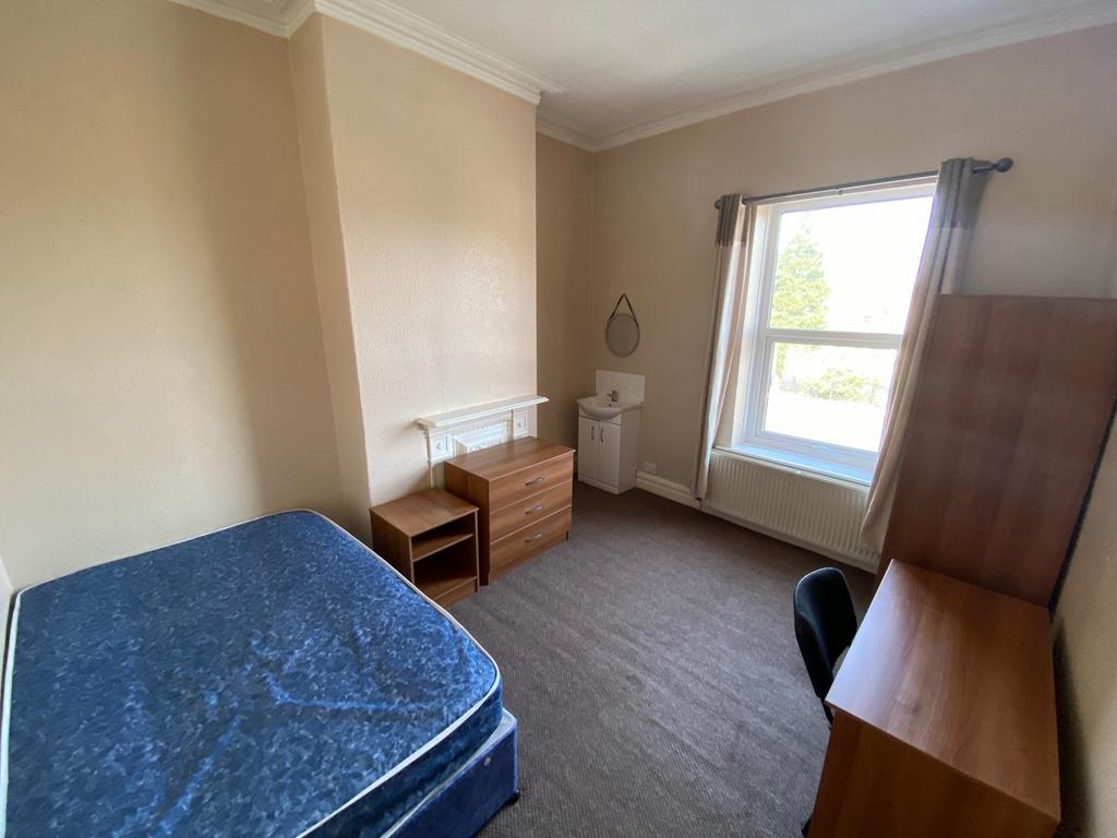 A spacious and well-lit double bedroom perfect ...