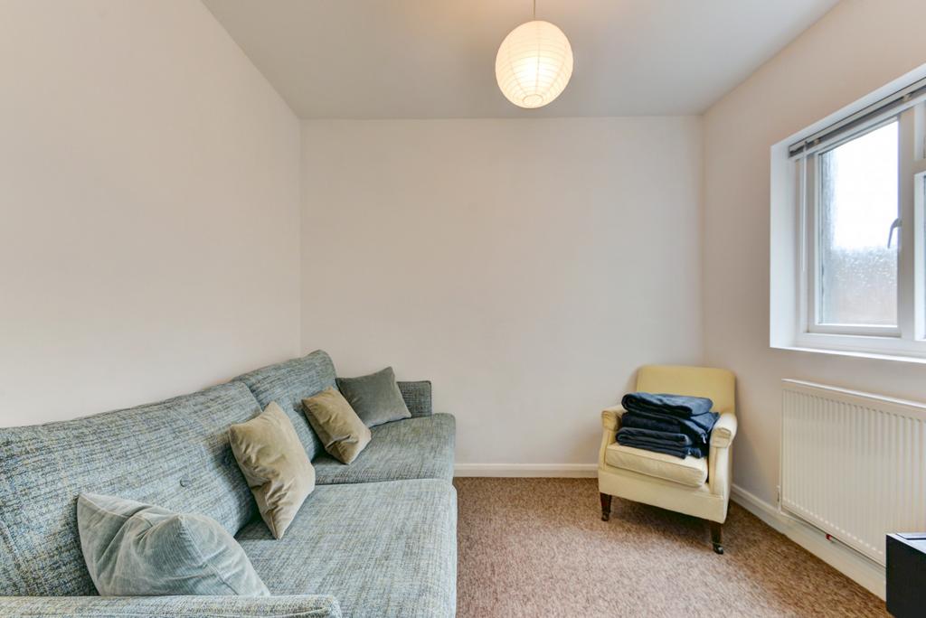 A bright and cozy living room featuring a comfo...