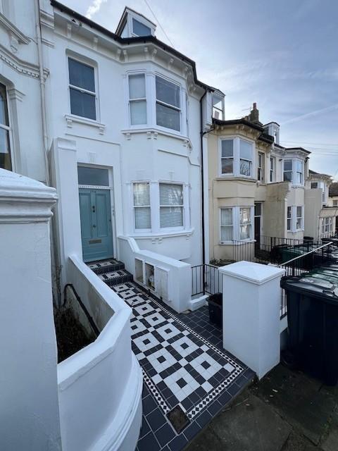 Exterior view of a charming terraced house feat...
