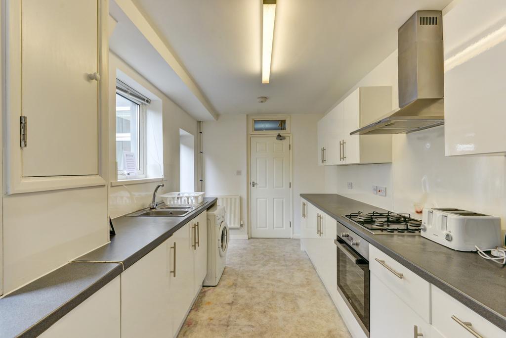 A bright, modern kitchen with ample countertop ...