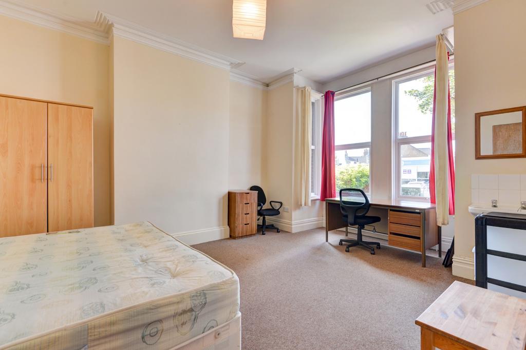 A bright, well-maintained bedroom with a large ...