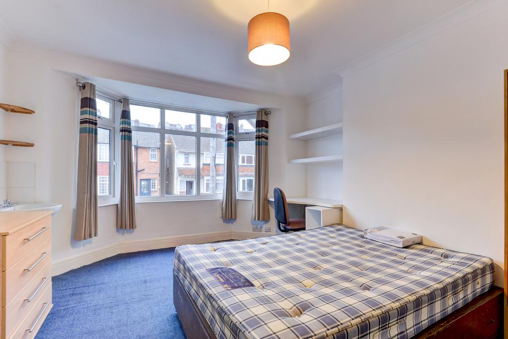 A bright and inviting double bedroom with large...