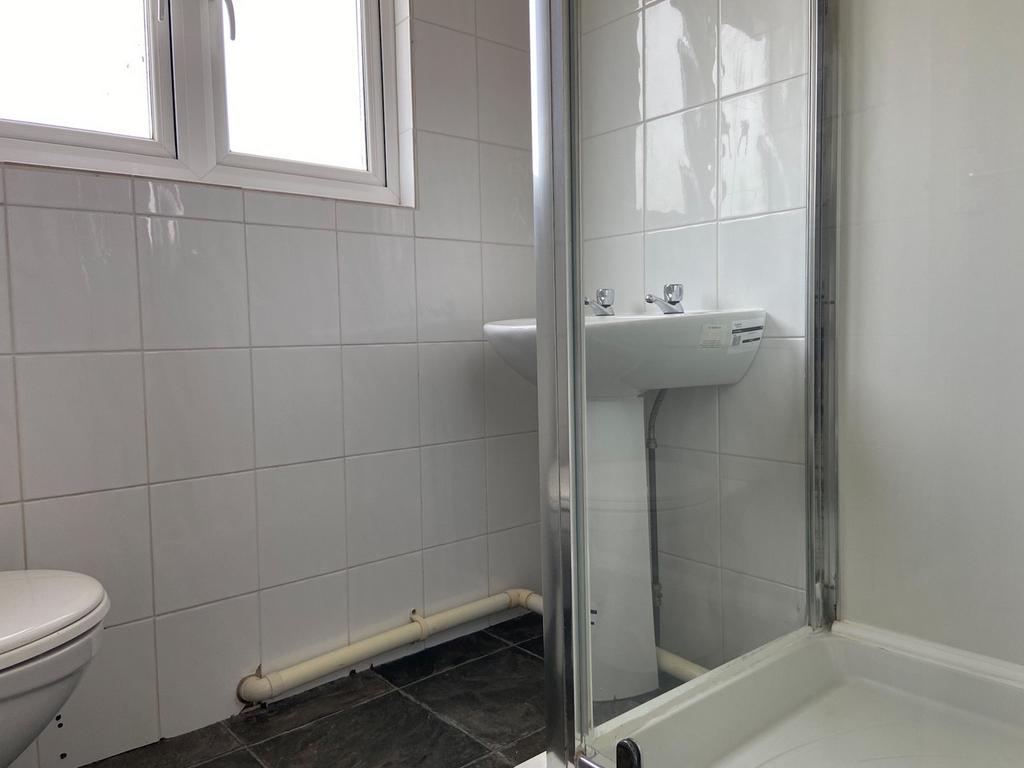 A clean and functional bathroom with a shower u...