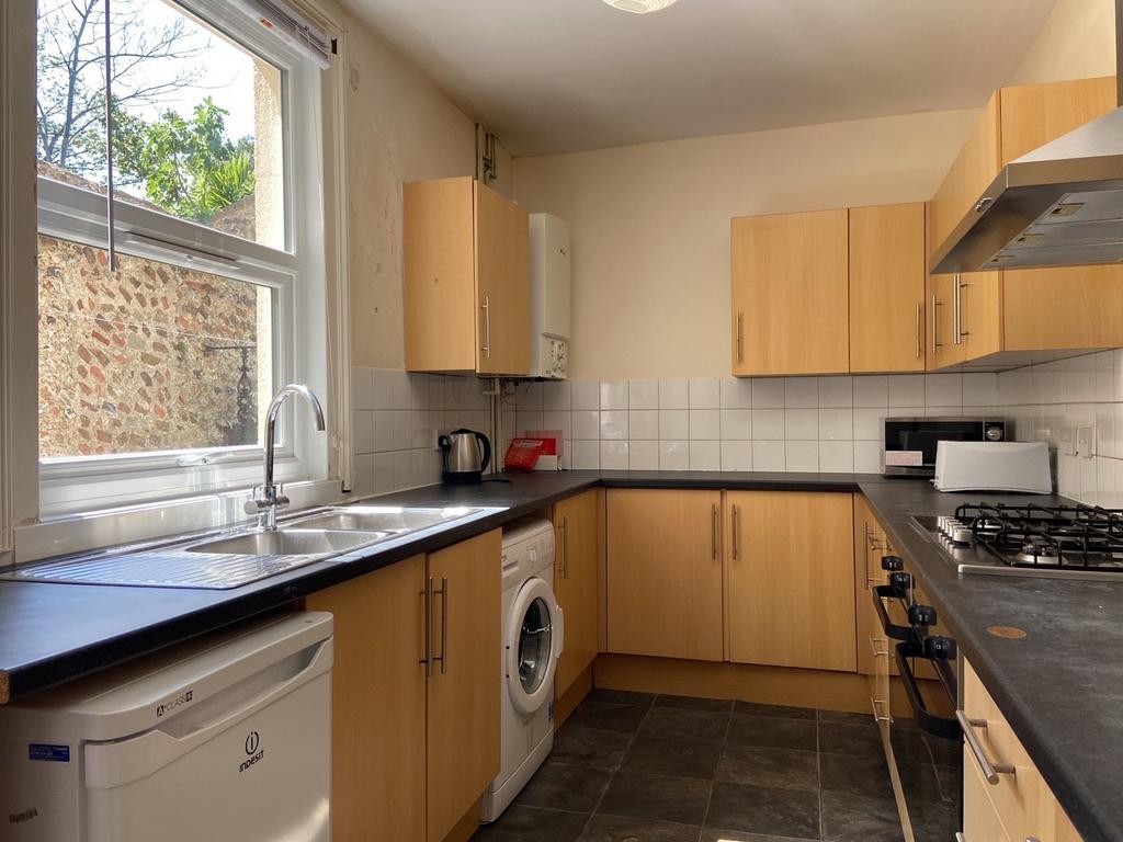 A modern kitchen with ample counter space, wood...