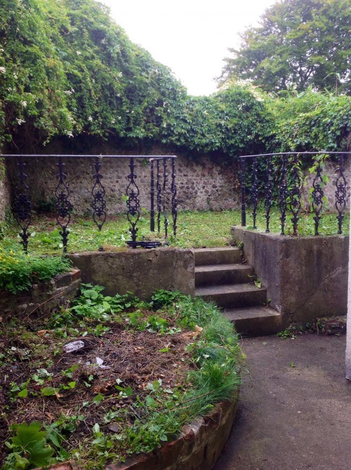 A lush garden area featuring mature greenery an...