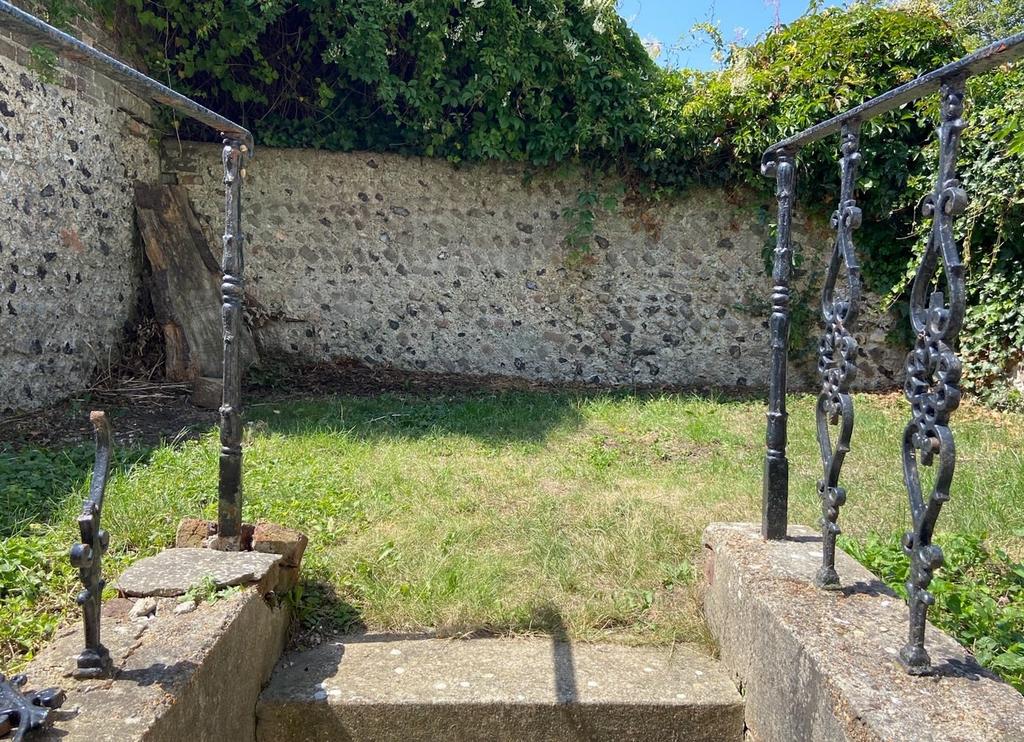 A well-maintained garden area with a lush green...